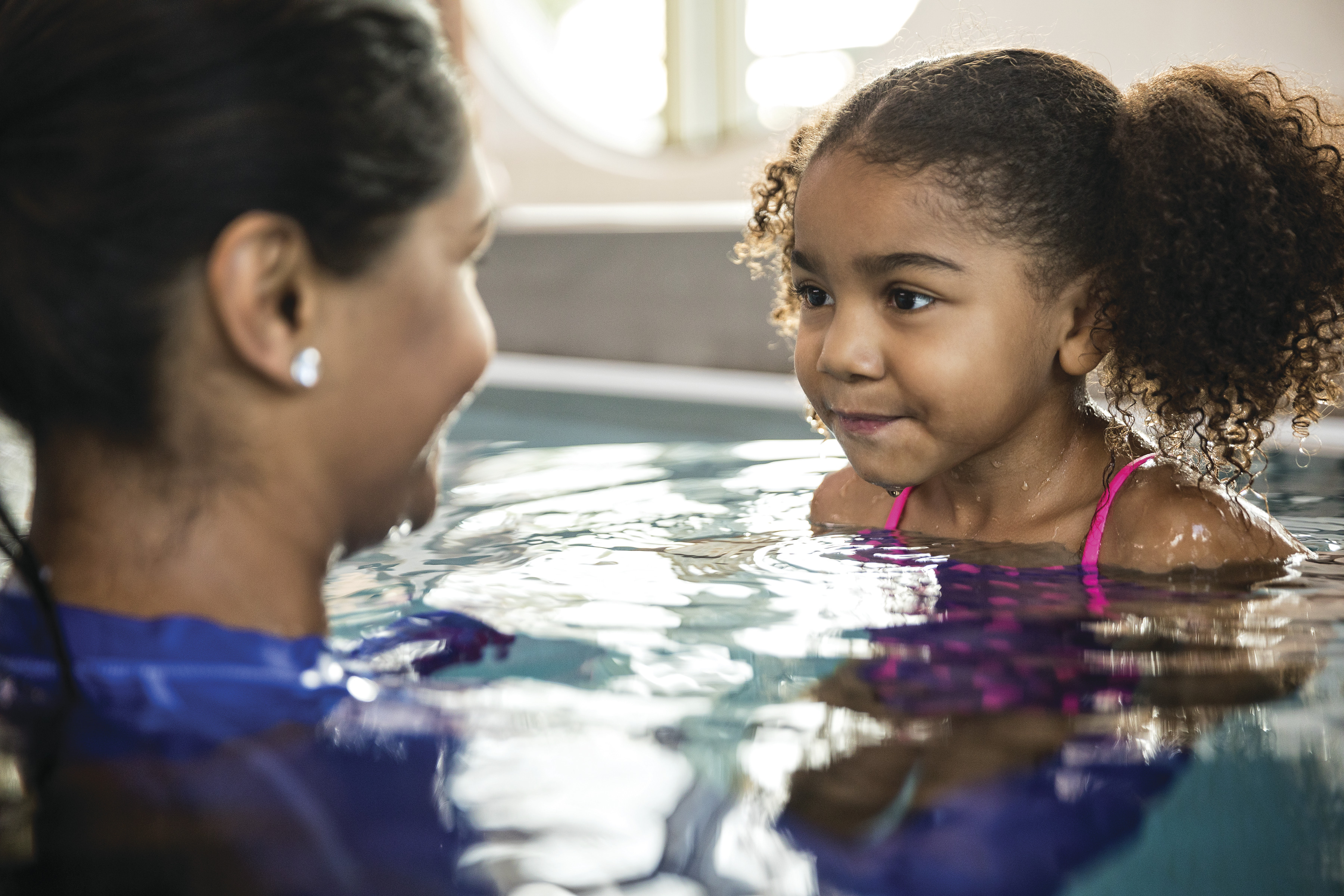 Adult and child in a pool Adult and child in a pool