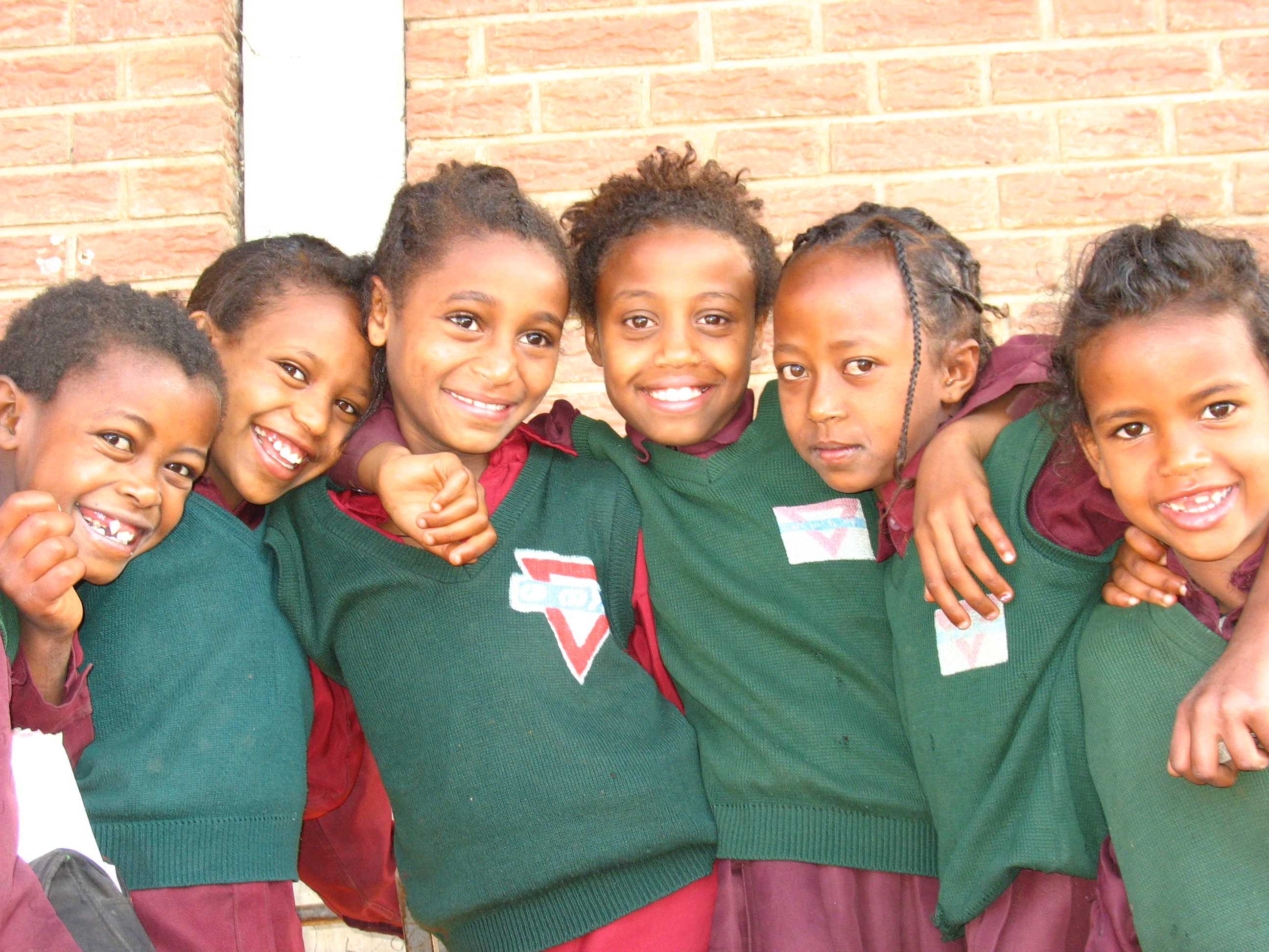 Smiling children with their arms around each other Smiling children with their arms around each other