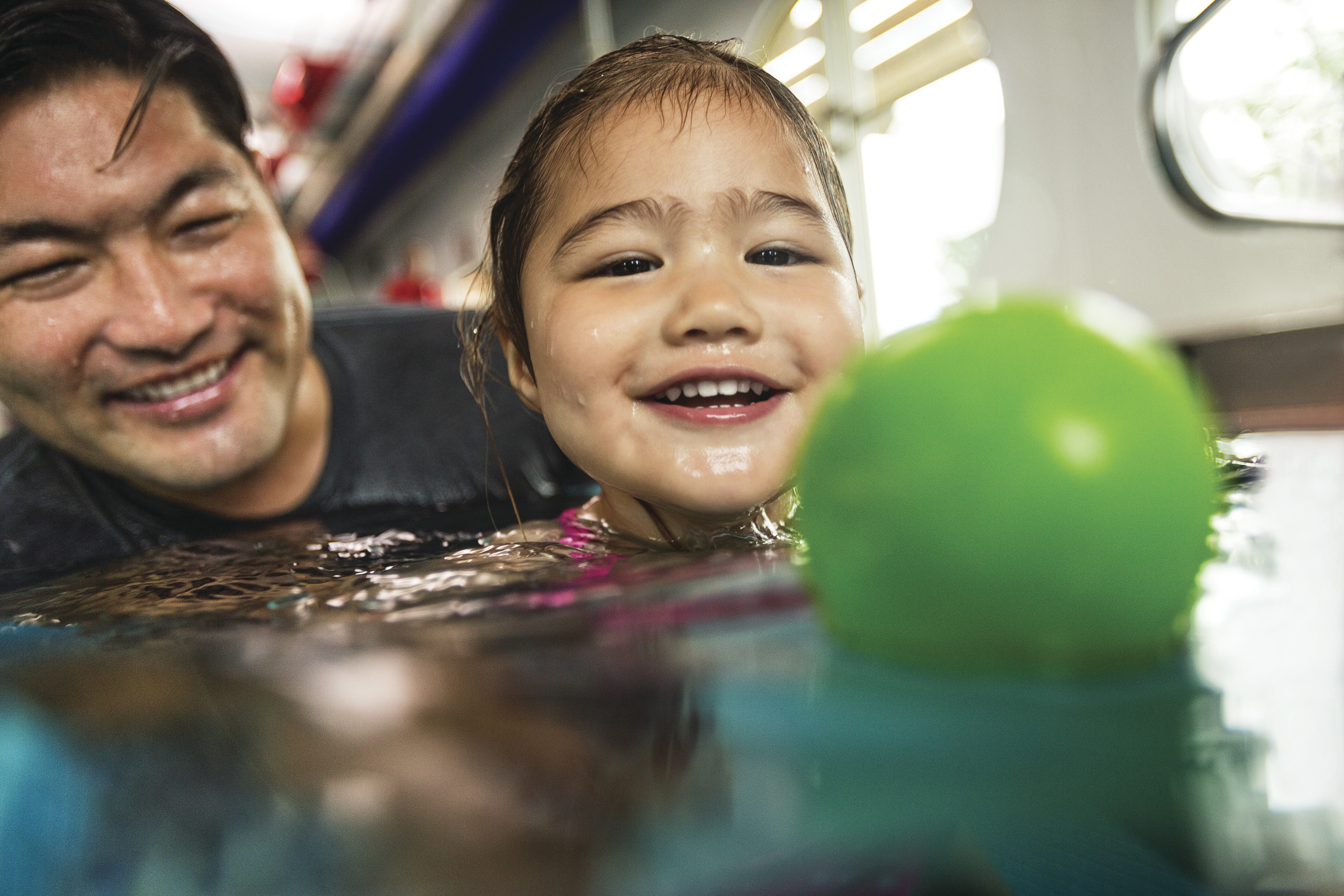 Adult and child swimming in the pool