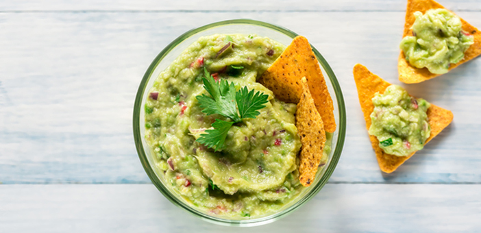Greek yogurt guacamole and chips in a bowl Greek yogurt guacamole and chips in a bowl