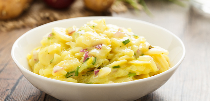 Potato salad in a white bowl Potato salad in a white bowl