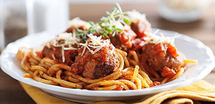 Spaghetti and meatballs in a white bowl Spaghetti and meatballs in a white bowl