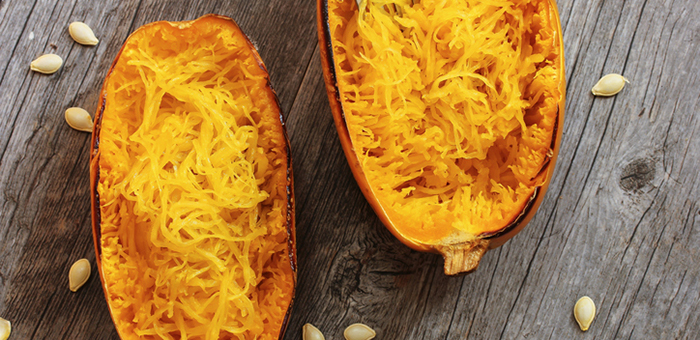 Baked spaghetti squash on a wooden tabletop Baked spaghetti squash on a wooden tabletop
