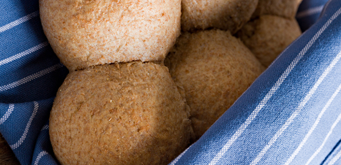 Wheat bread rolls wrapped in a blue cloth Wheat bread rolls wrapped in a blue cloth