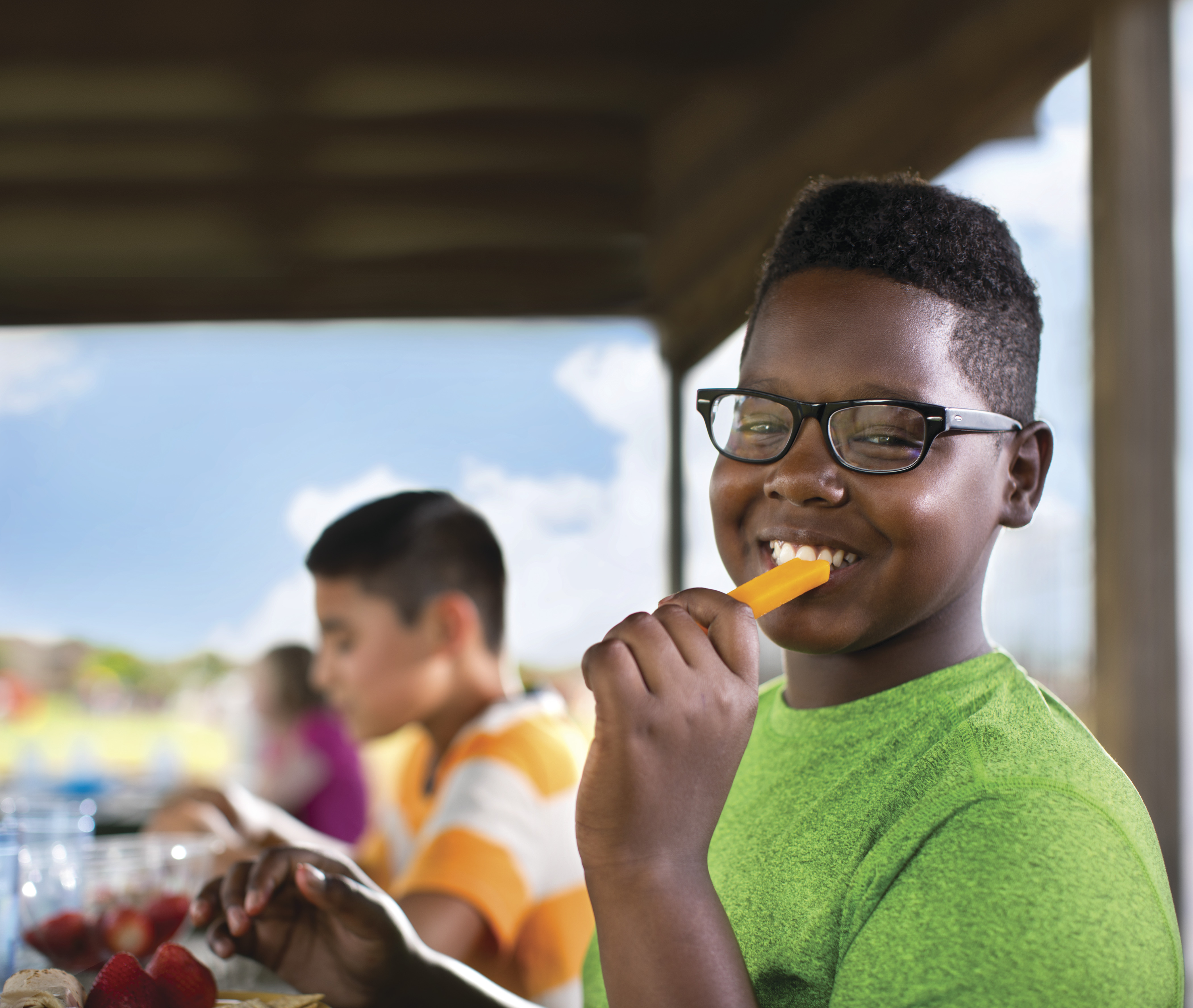 Smiling child eating a cheese stick Smiling child eating a cheese stick