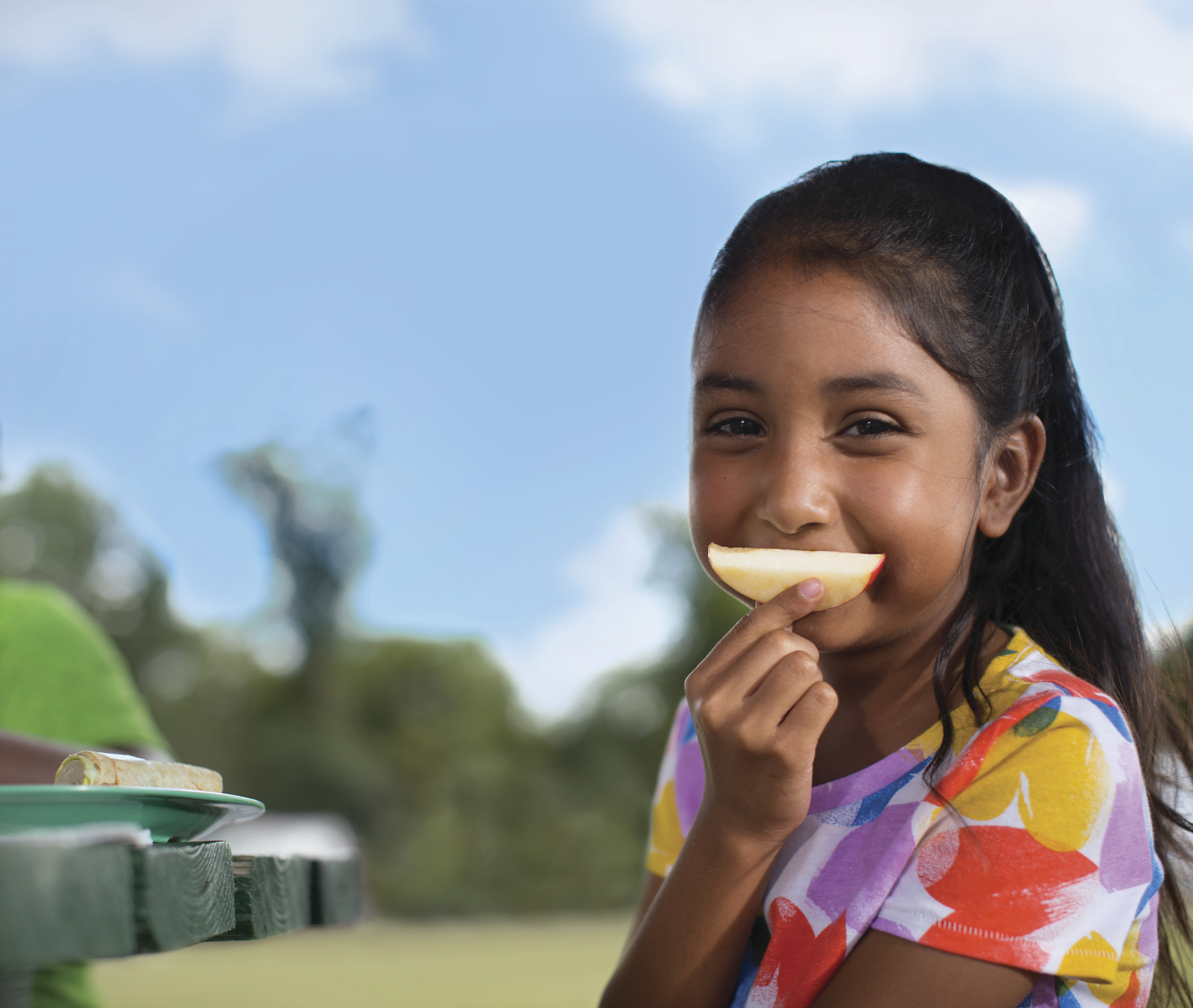 Youth in field eating healthy meal