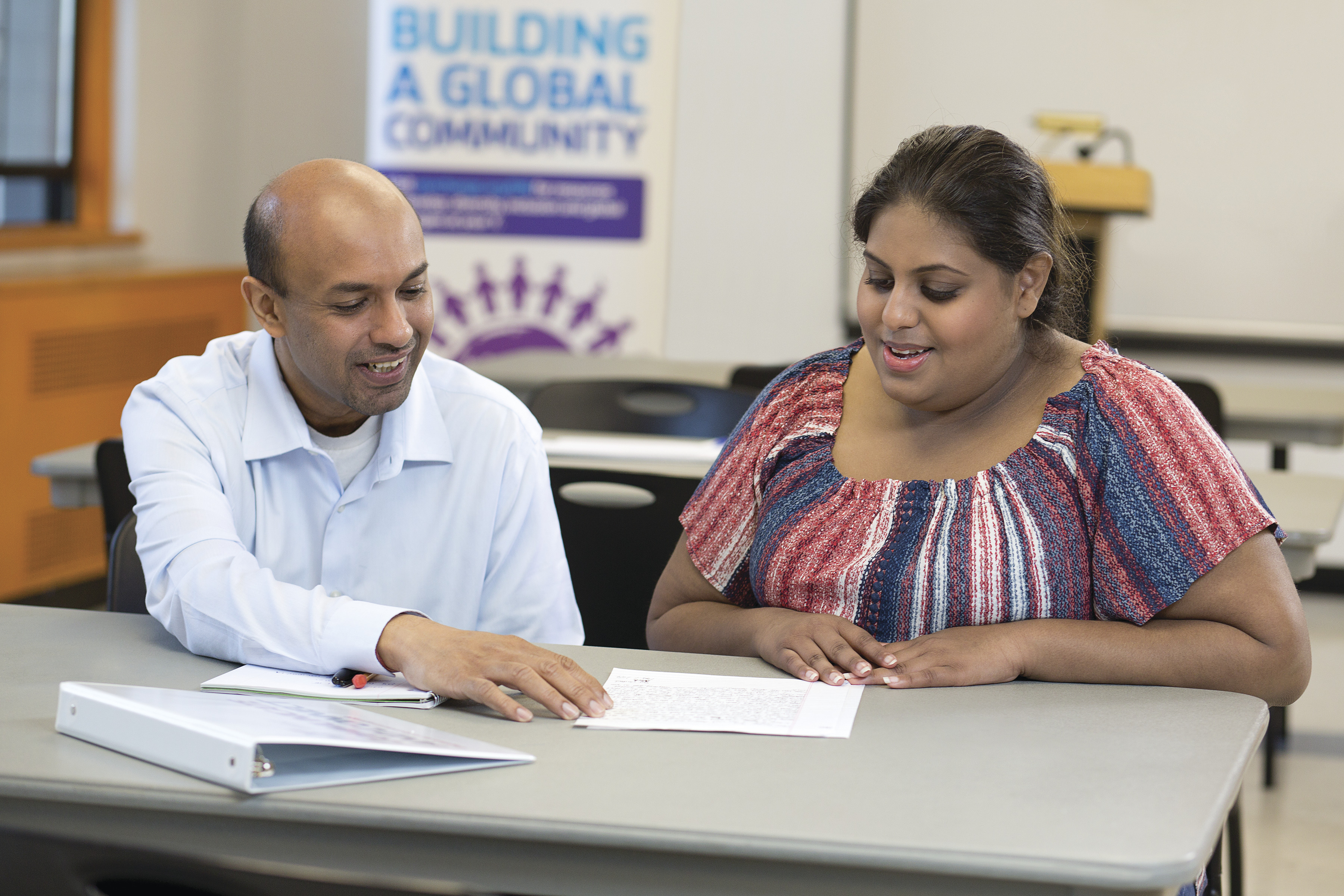 YMCA staff helping immigrants with paperwork
