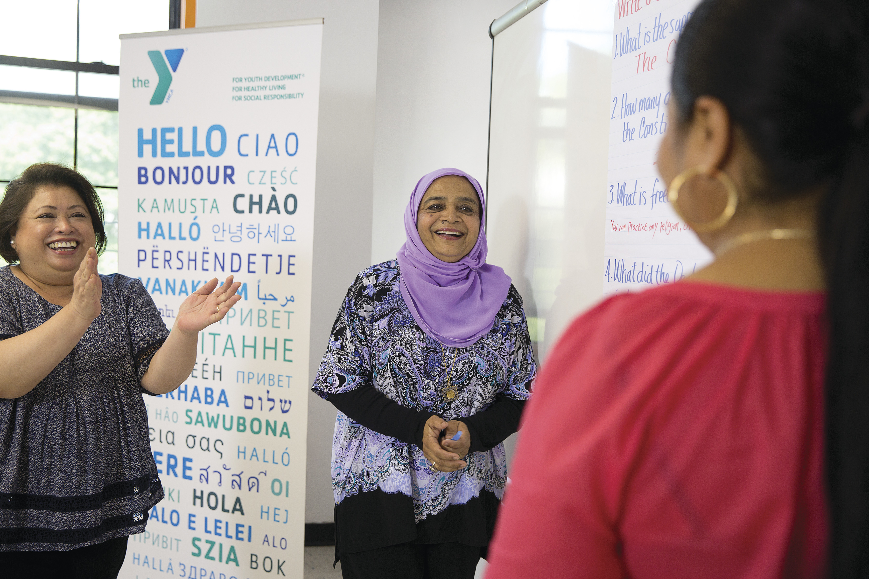 Women giving a standing ovation to a newcomer at the YMCA Women giving a standing ovation to a newcomer at the YMCA