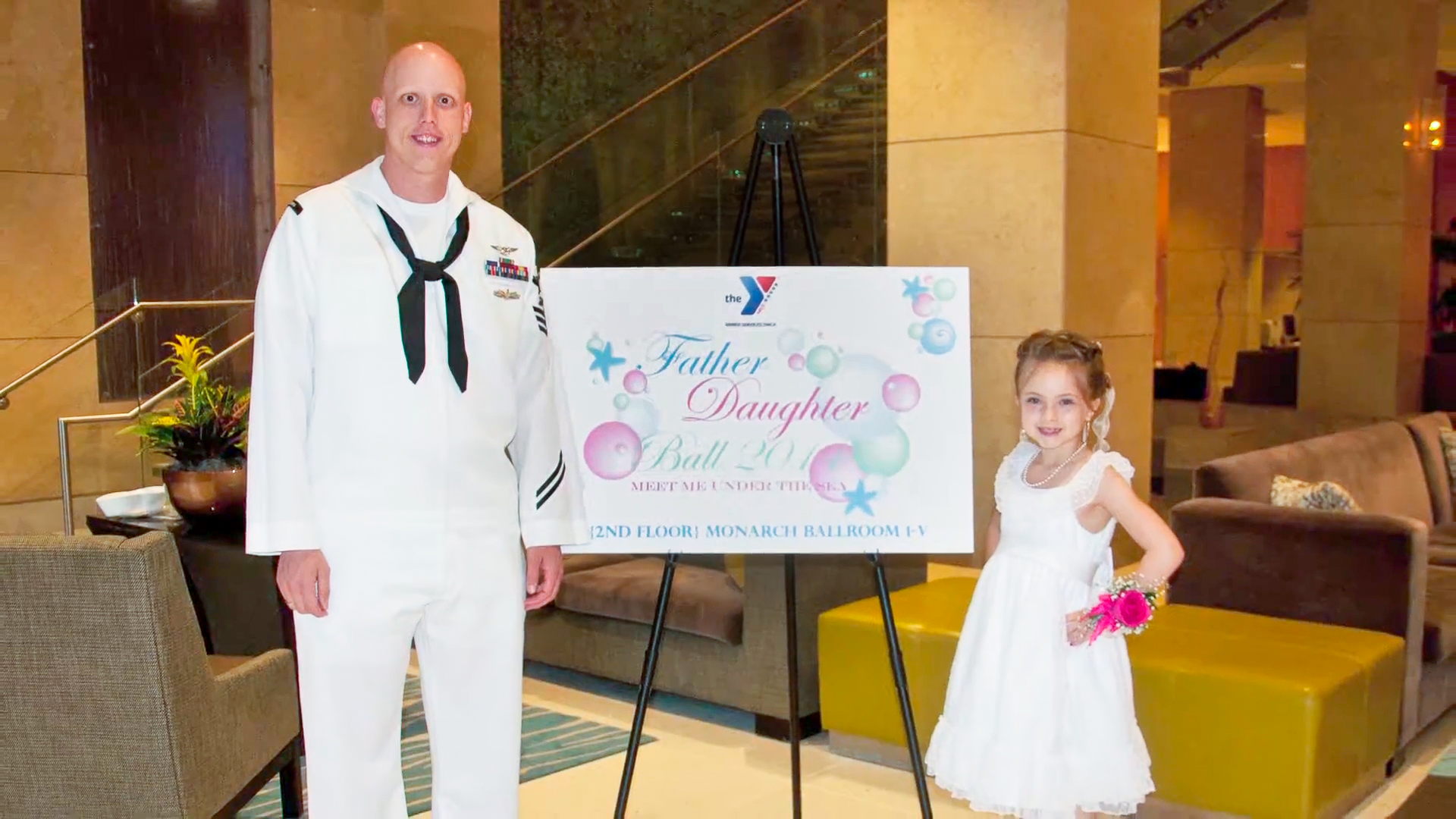 Man and daughter pose during YMCA military outeach event Man and daughter pose during YMCA military outeach event
