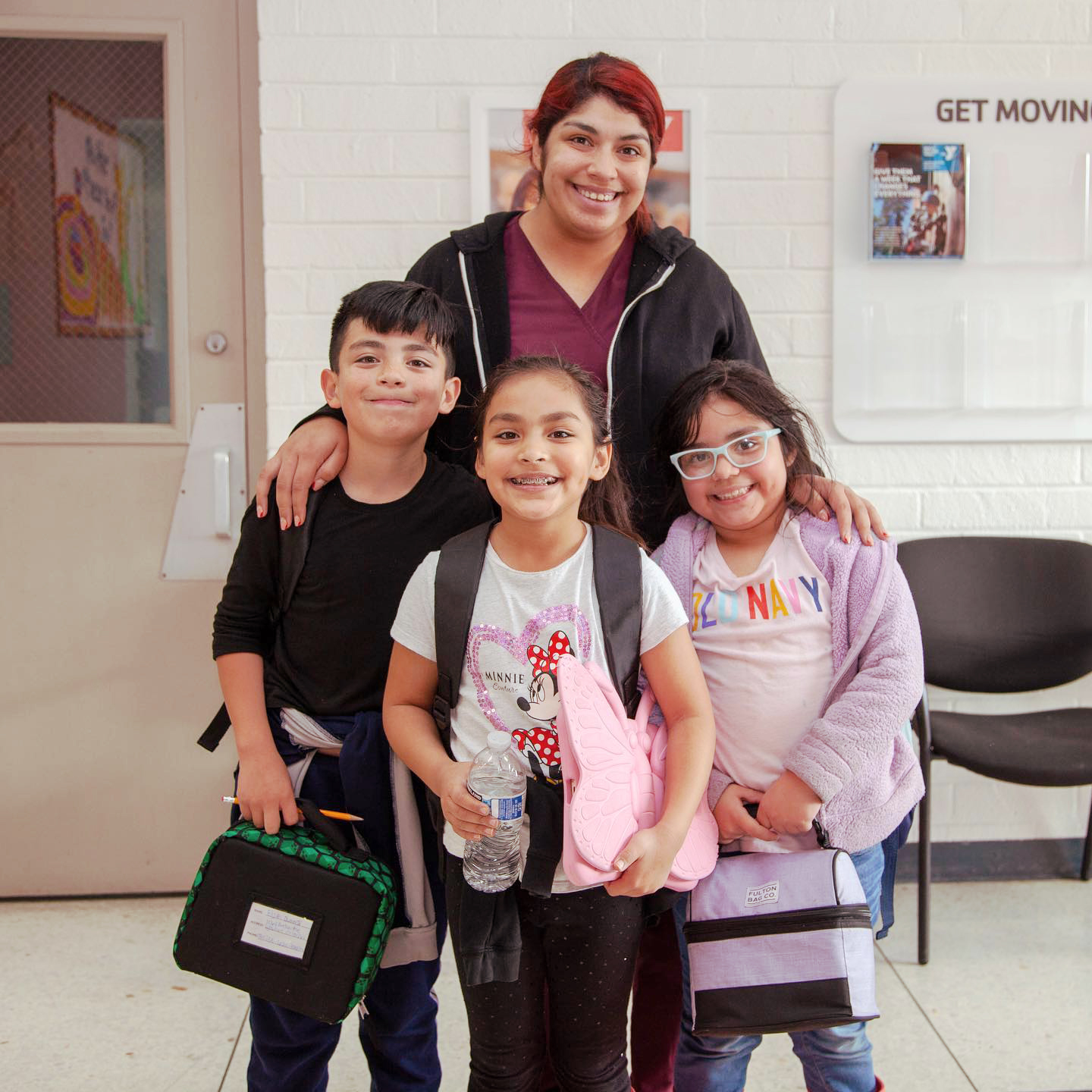 Children standing with their mom at the Y Children standing with their mom at the Y