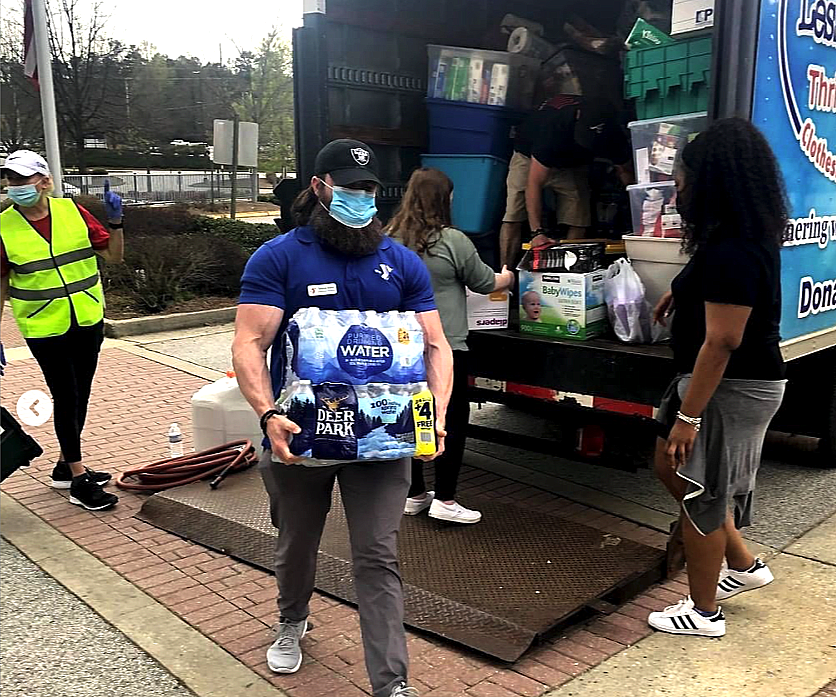 People unloading a truck volunteering People unloading a truck volunteering