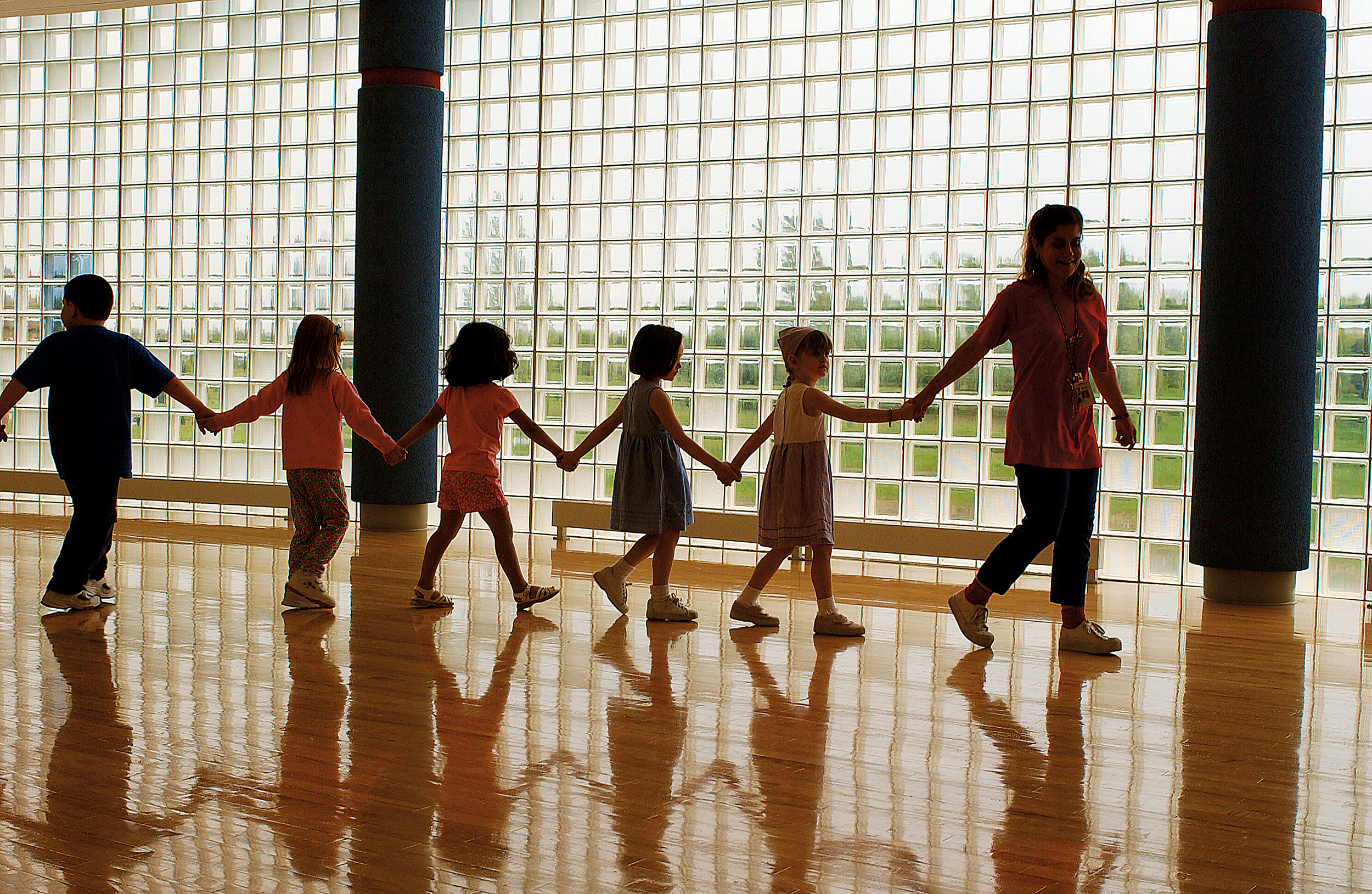 Children holding hands while walking