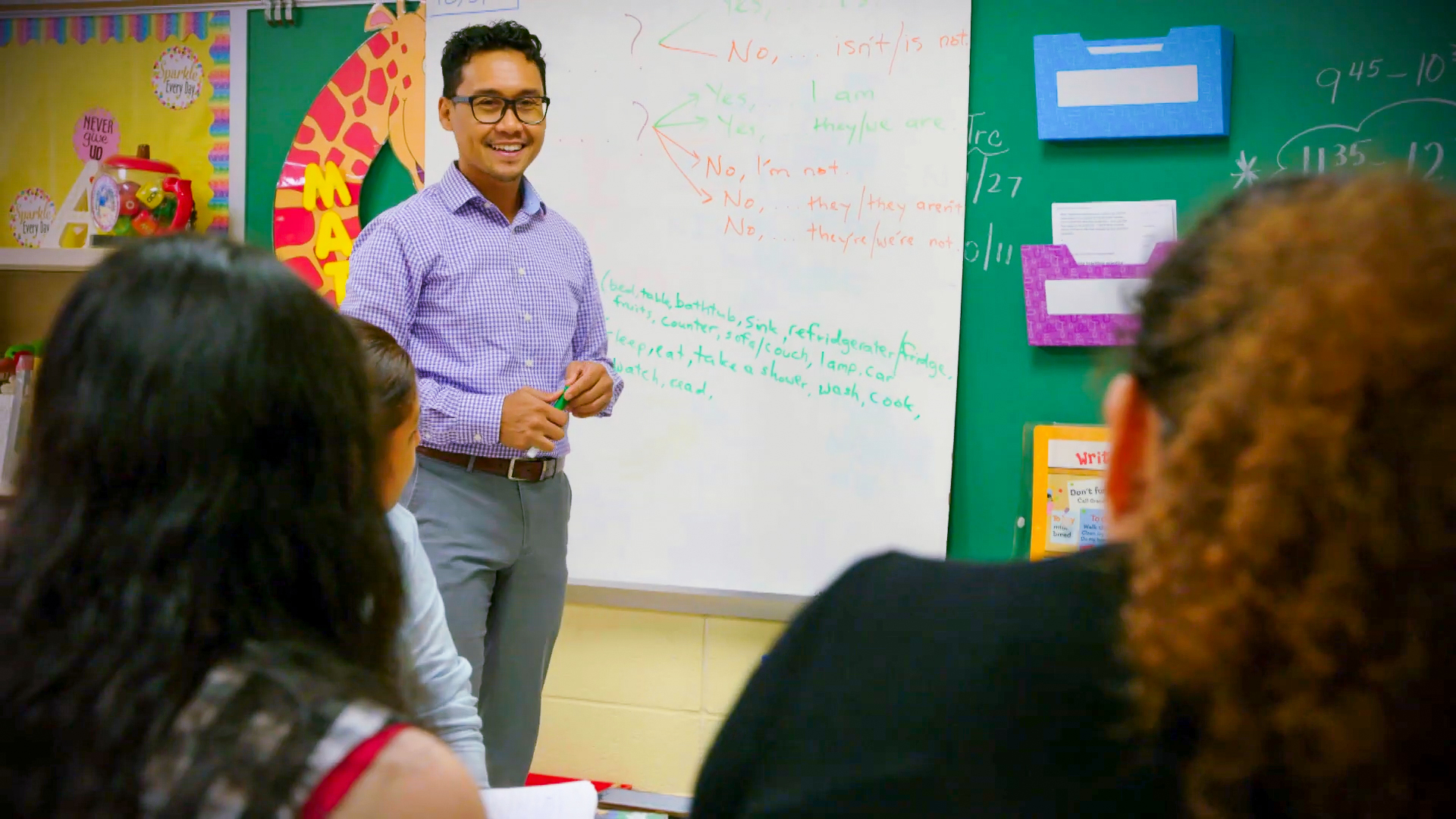 Man teaching english as a second language to students Man teaching english as a second language to students