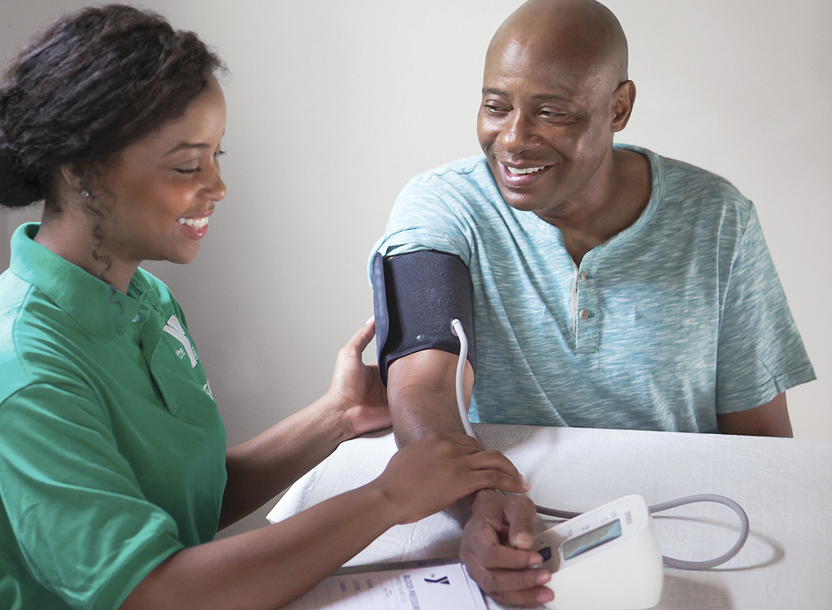 YMCA faculty helping man take blood pressure for diabetes program YMCA faculty helping man take blood pressure for diabetes program
