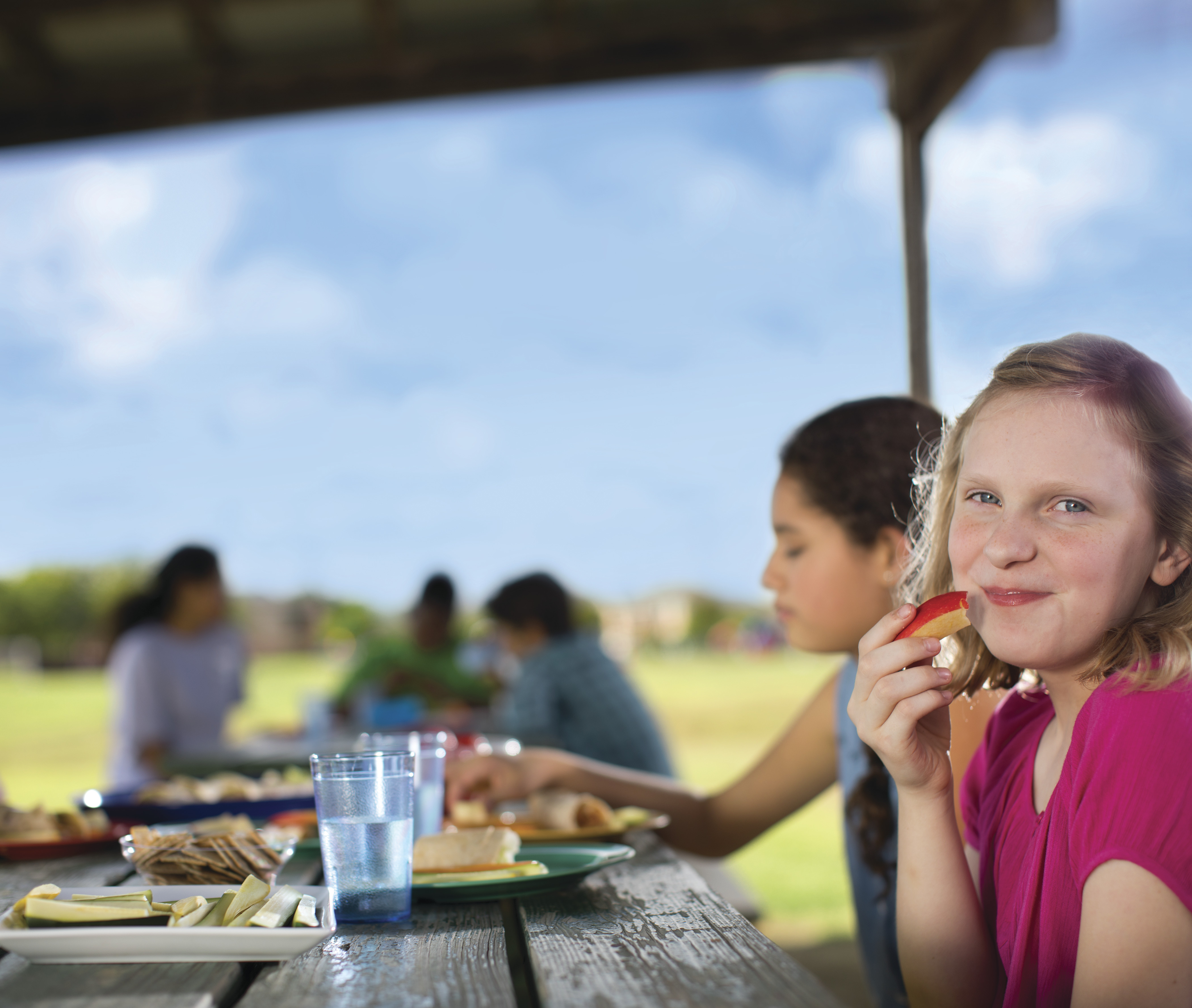 Child eating meal outdoors - YMCA