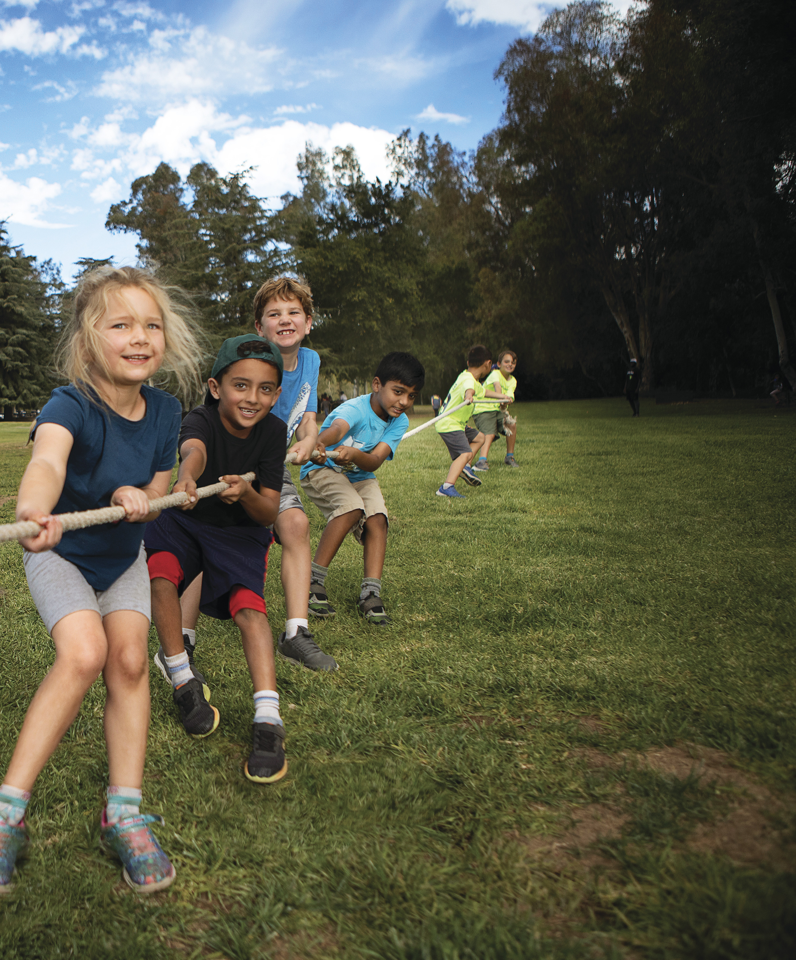 group of children playing tug of war at day camp