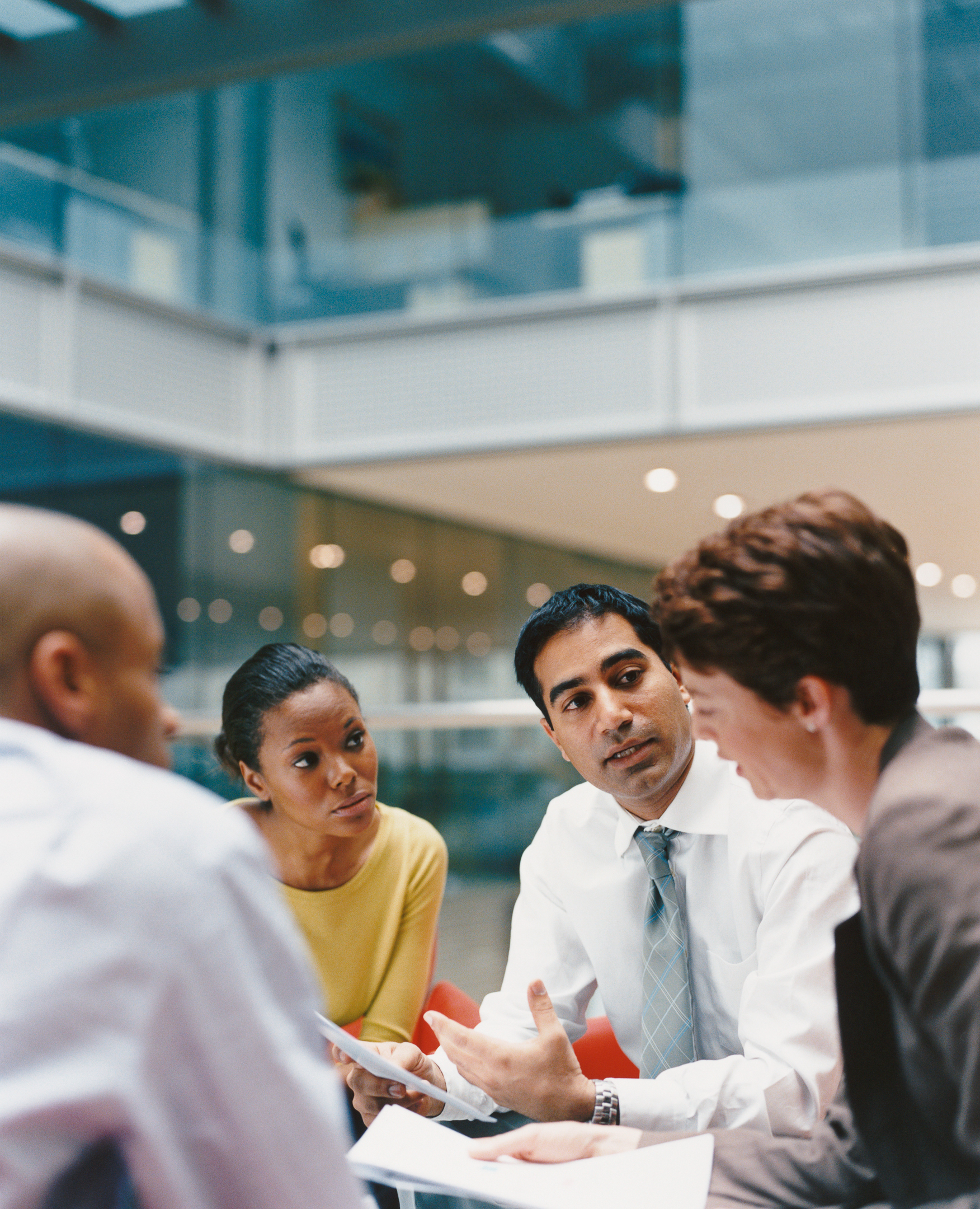 Business People Sitting in an Office Building Having a Meeting