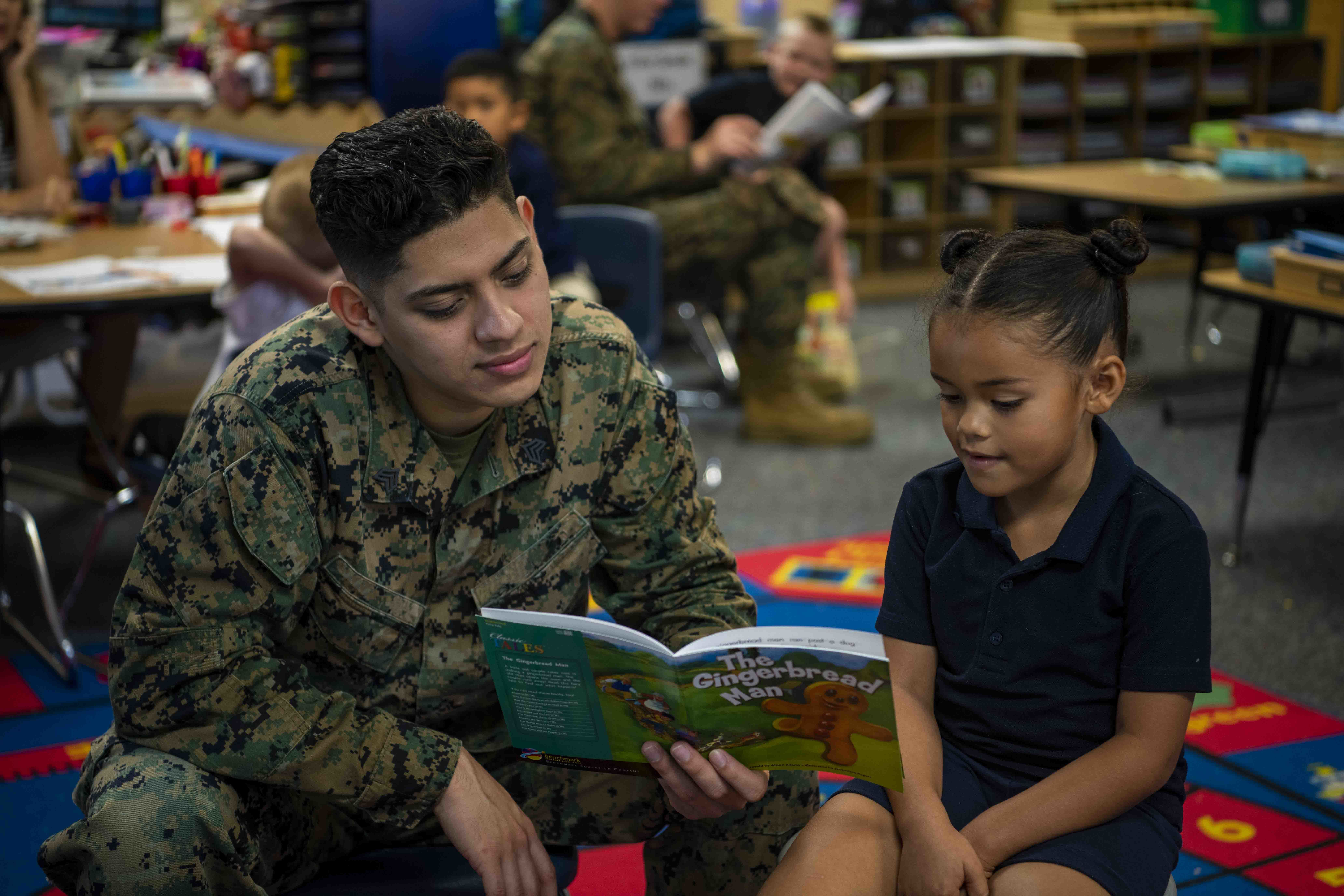 military father reading book with child at YMCA military father reading book with child at YMCA