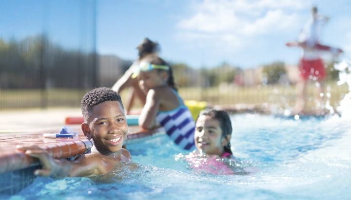 Three kids in an outdoor pool Three kids in an outdoor pool