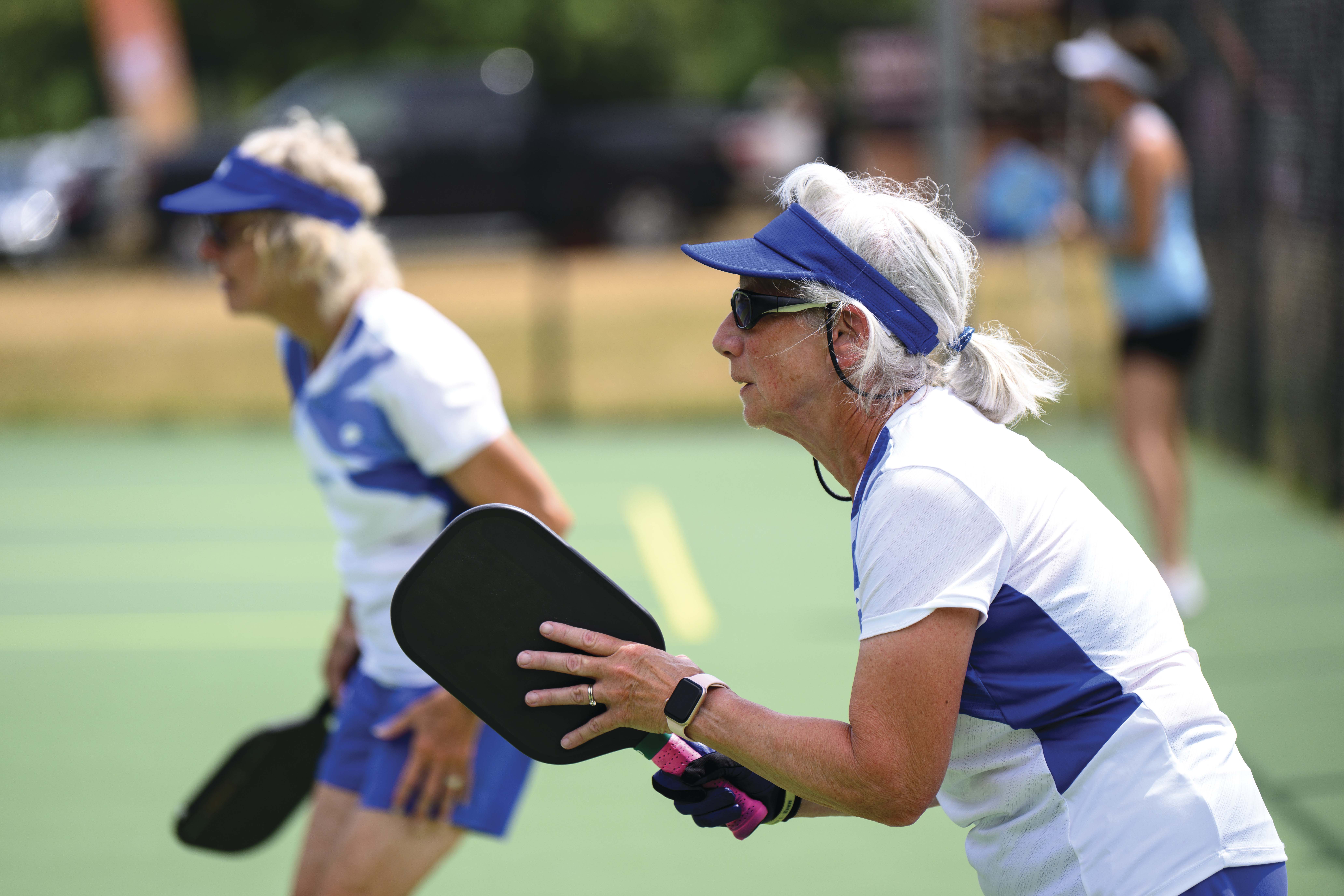 Two women playing pickleball Two women playing pickleball