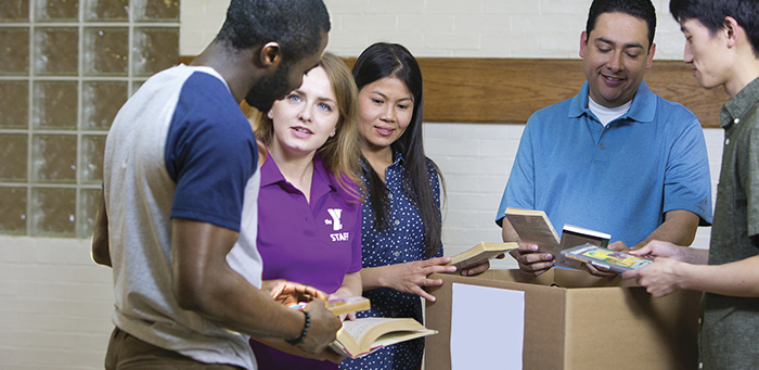 Teens and adults unpacking books