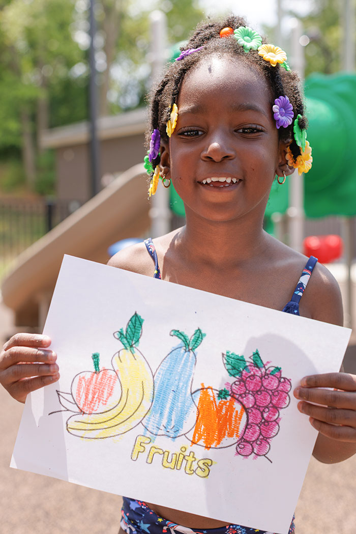 Healthy Kids Day blog: child with drawing of fruits.