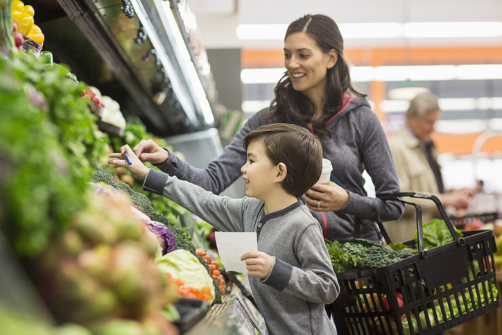 Boy and mom is grocery store