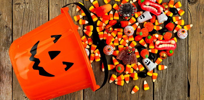 Jack-o-lantern bucket spilling over with Halloween candy