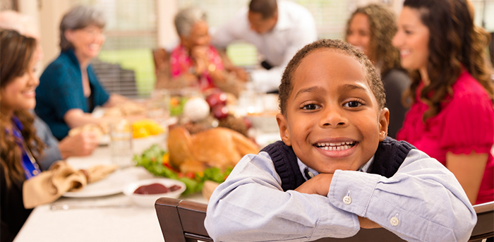 Child and family at holiday dinner table