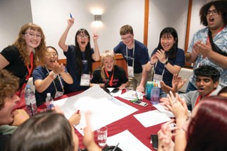 A group of young people participate in a group activity at a YMCA event