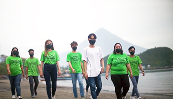 Young people from the Albay YMCA in the Philippines walking on a beach