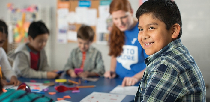 Child smiling in a classroom