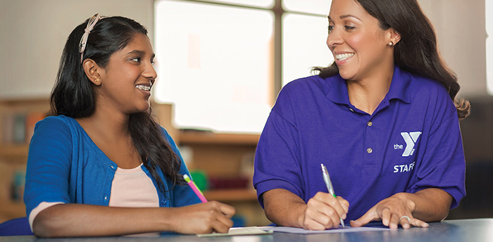 Adult and child writing on paper