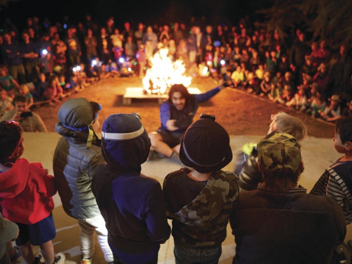 Large group of children around the campfire