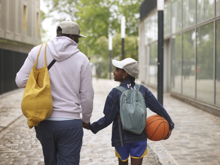 Boy and dad holding hands after basketball