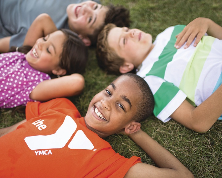 Kids smiling and lying on the grass Kids smiling and lying on the grass