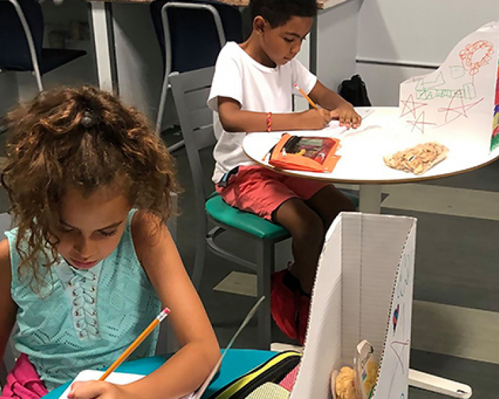 Children working on homework at child care center