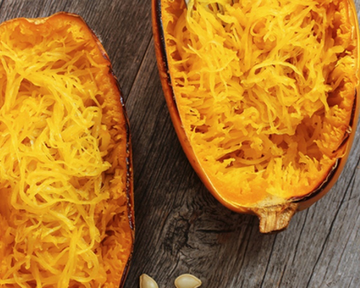 Baked spaghetti squash on a wooden tabletop