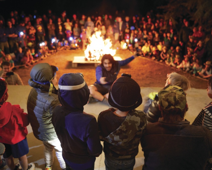 Large group of children around the campfire