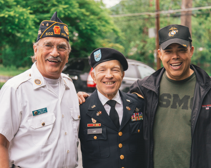 Three military veterans standing outside Three military veterans standing outside