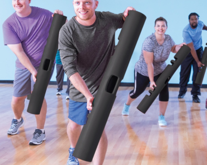 Man holding foam roller in firness class Man holding foam roller in firness class