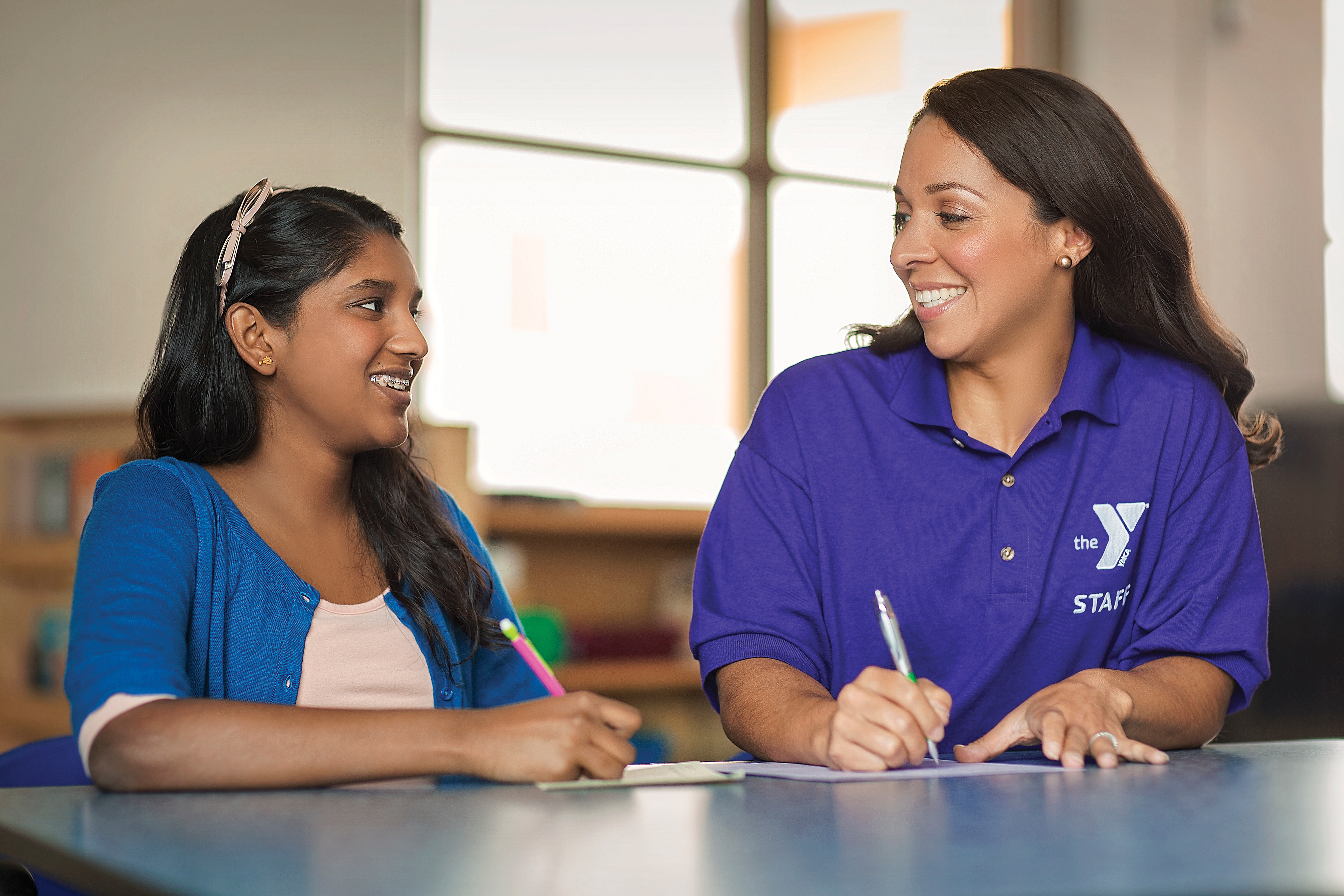 Teen working with a tutor on homework Teen working with a tutor on homework