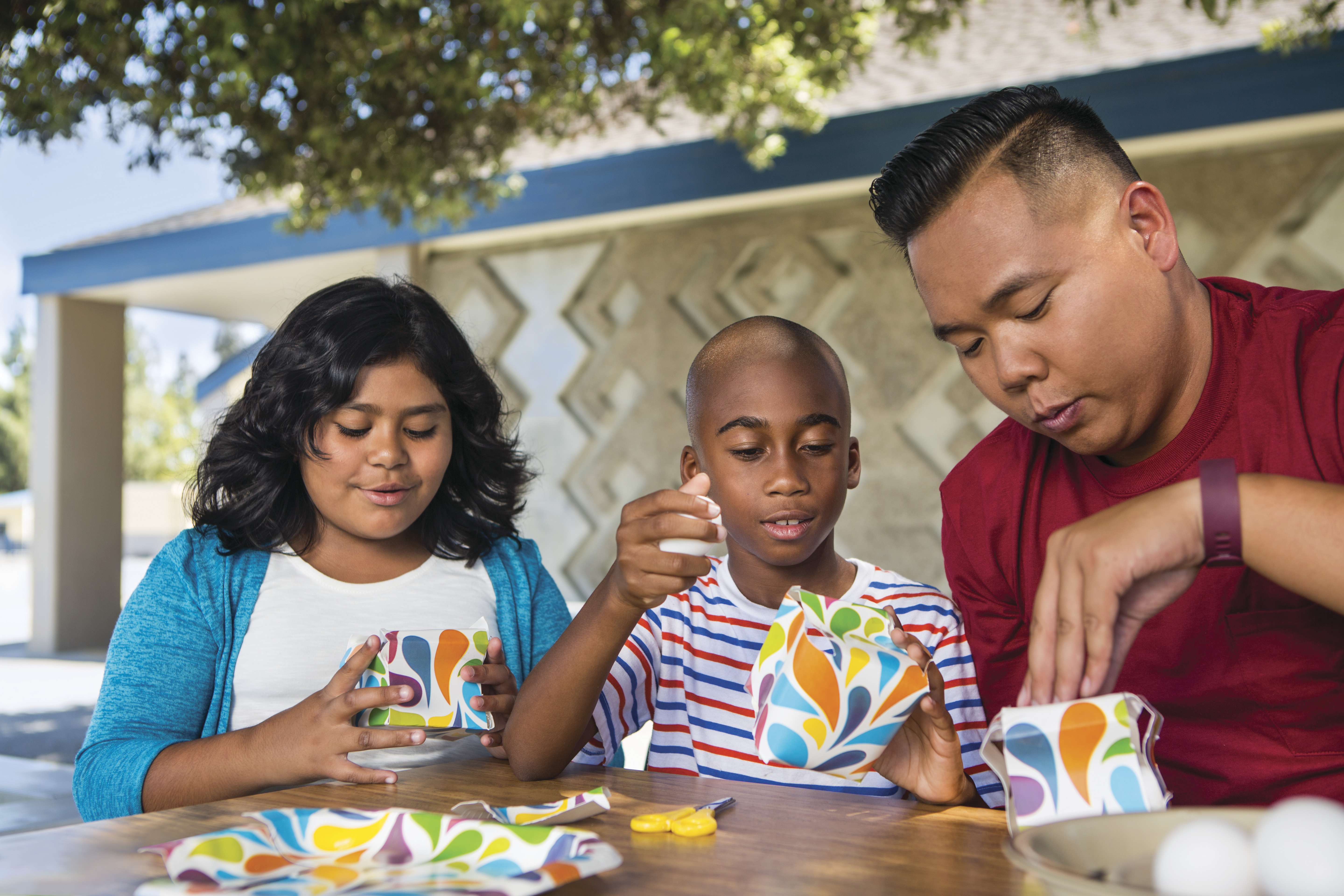 Kids doing crafts together with an adult Kids doing crafts together with an adult