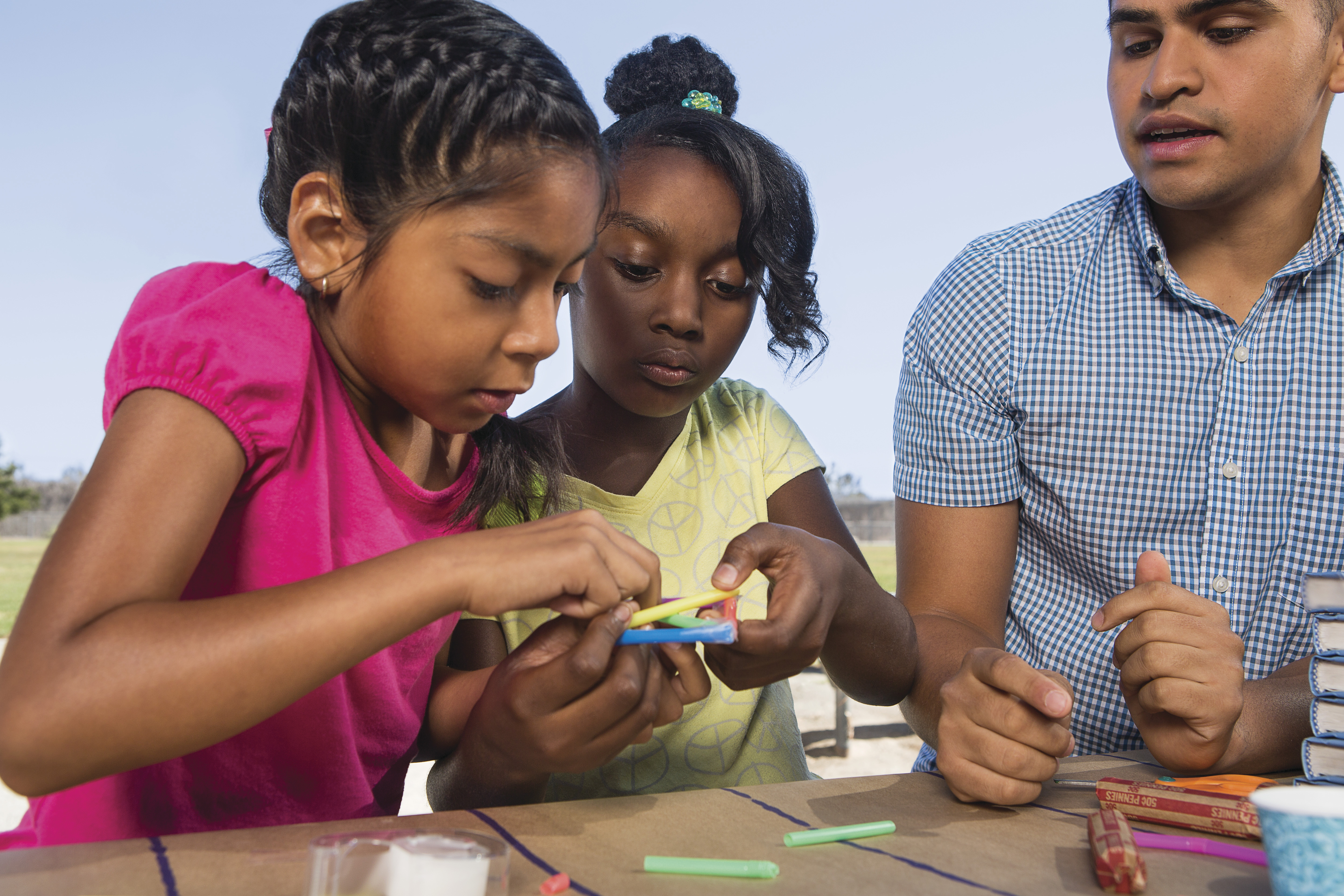 Kids doing crafts together with an adult Kids doing crafts together with an adult