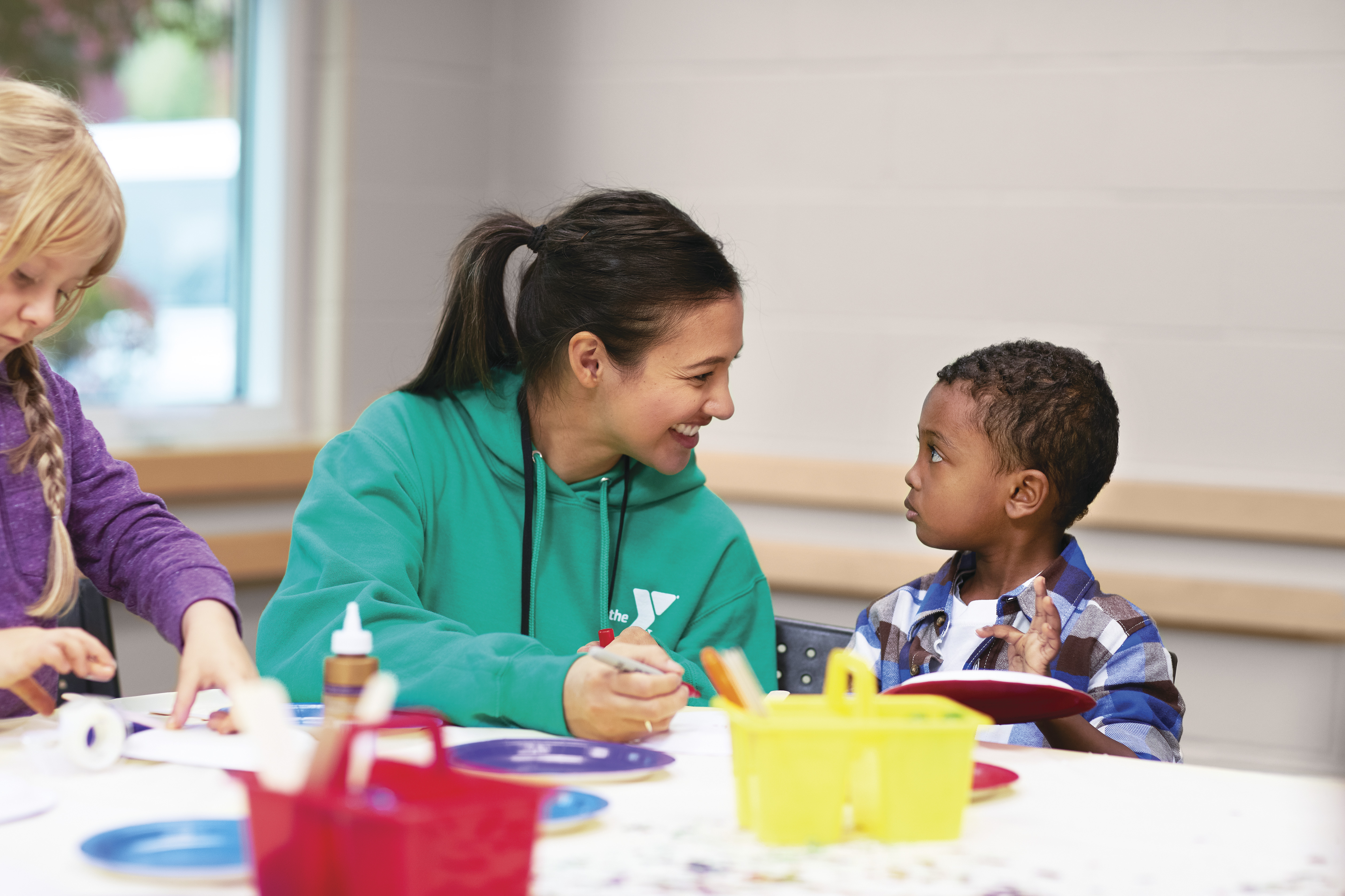 YMCA staff helping child