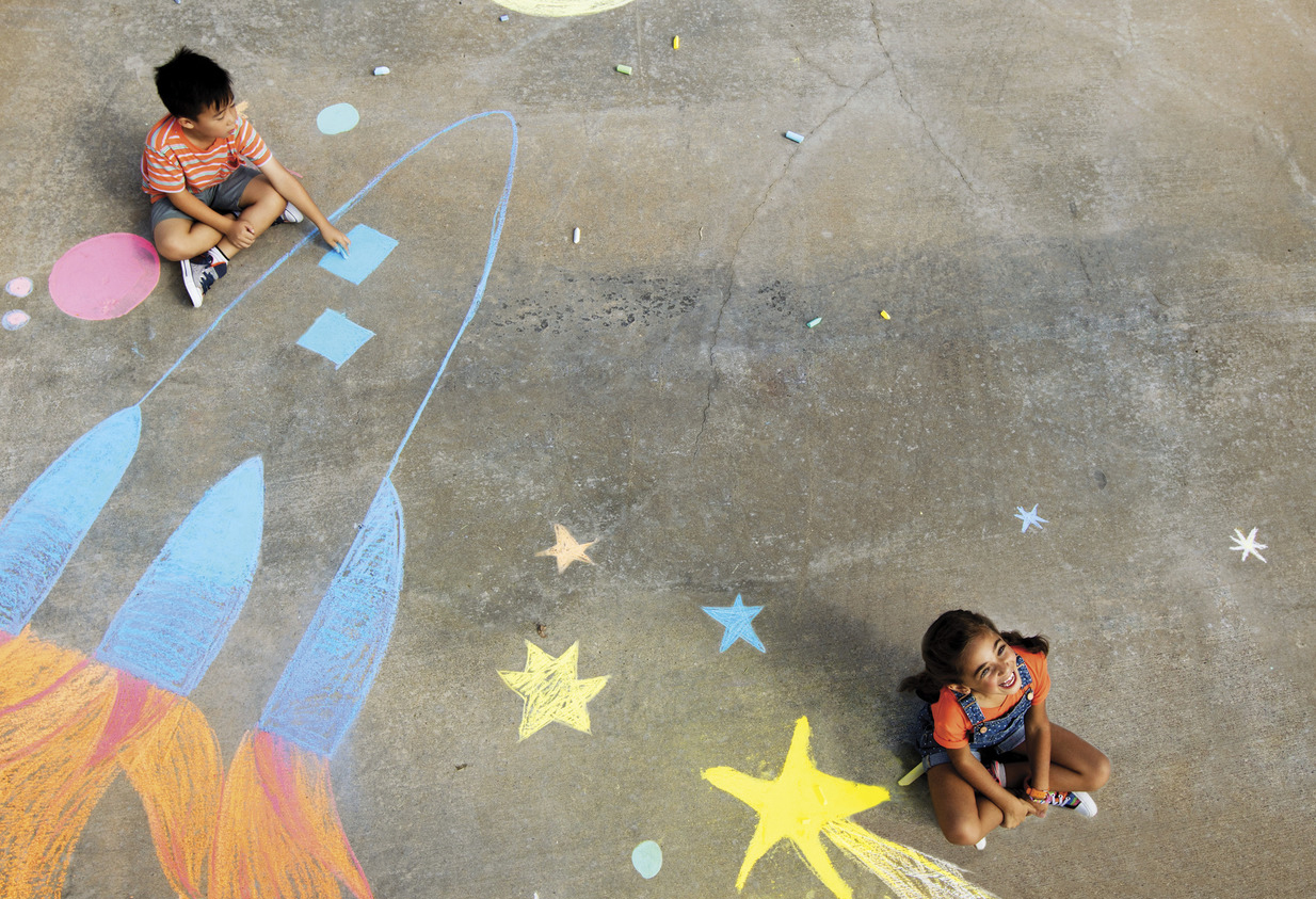 Children playing with chalk on sidewalk Children playing with chalk on sidewalk