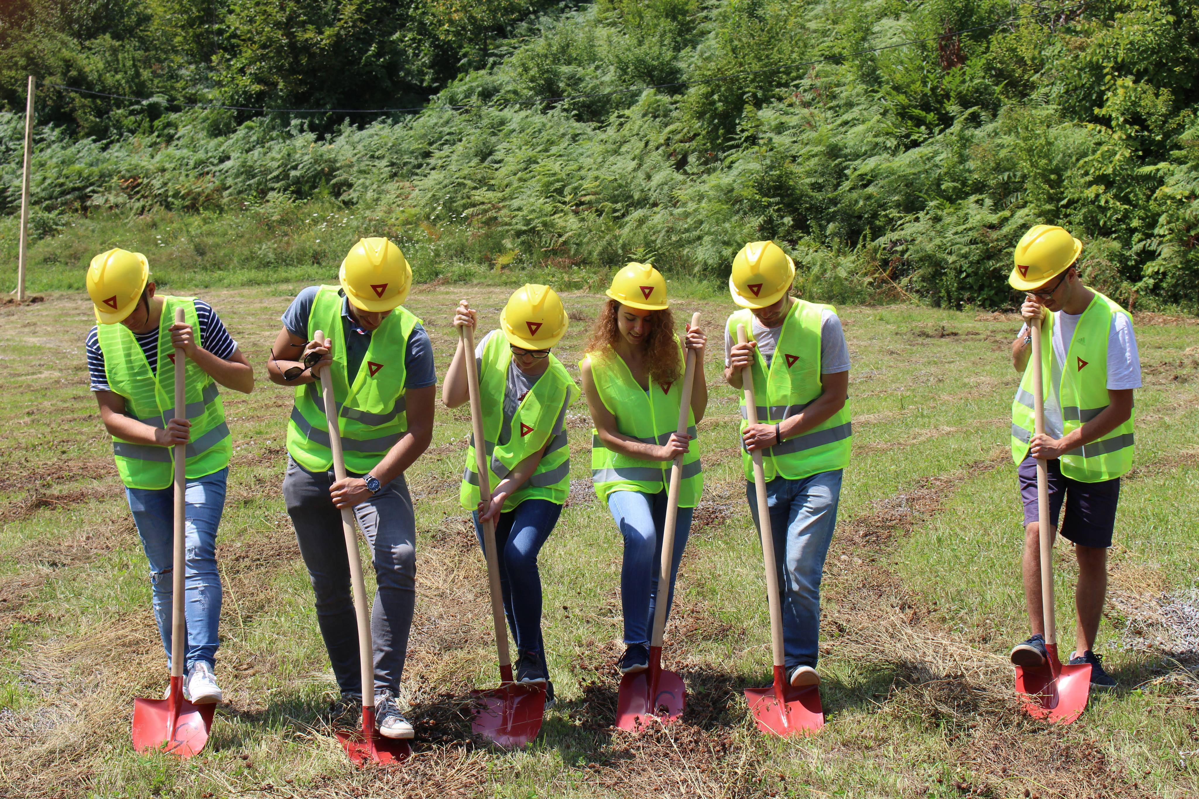 Young adults breaking ground with shovels in Kosovo Young adults breaking ground with shovels in Kosovo