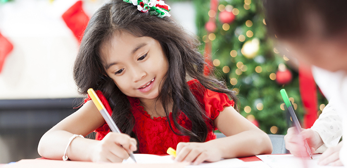 Child writing holiday notes