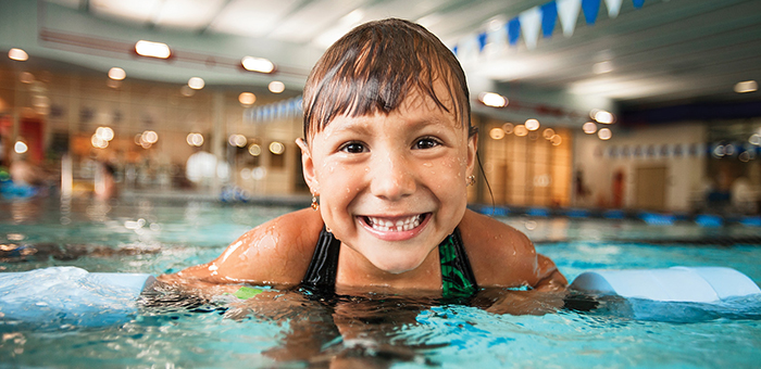 Smiling child swimming