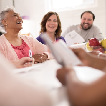Adults having discussion at table Adults having discussion at table